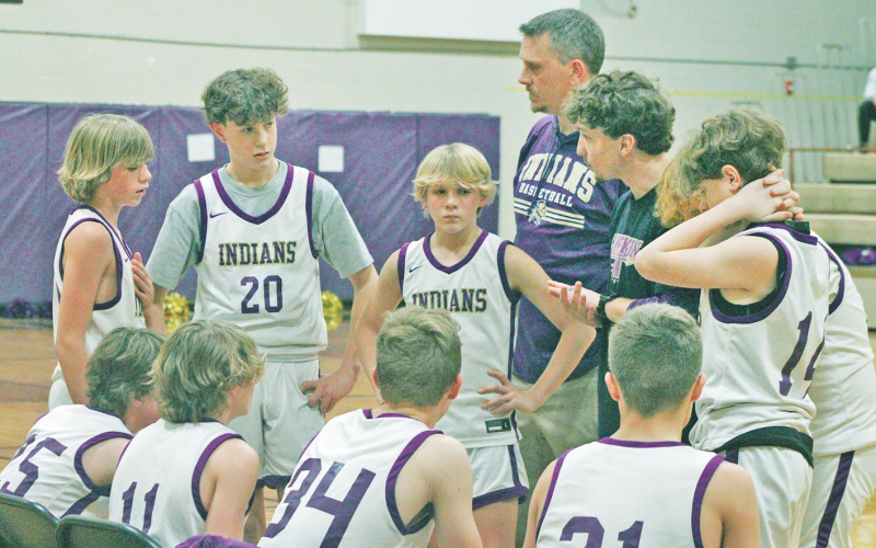 The Lumpkin County seventh grade boys team rallies during a time out.