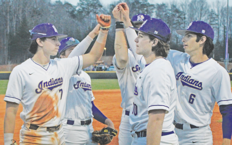 The Lumpkin County High School baseball team rallies together before storming the field against the Fannin County Rebels.
