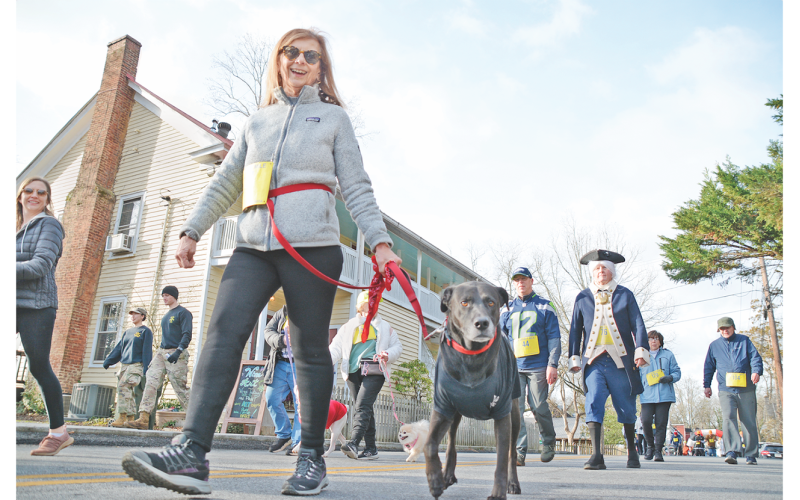 Dahlonega resident Penny Sharp and her dog Clarence Oddbody make up some time as they race through downtown in the Wimpy Mile.