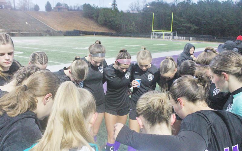 The Lumpkin County High School girls’ soccer team takes a moment before their big game.