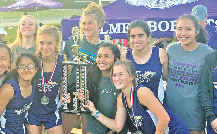 The Lady Indians cross country team shows off the hardware they earned after winning the Gilmer County Cross Country Invitational last week.