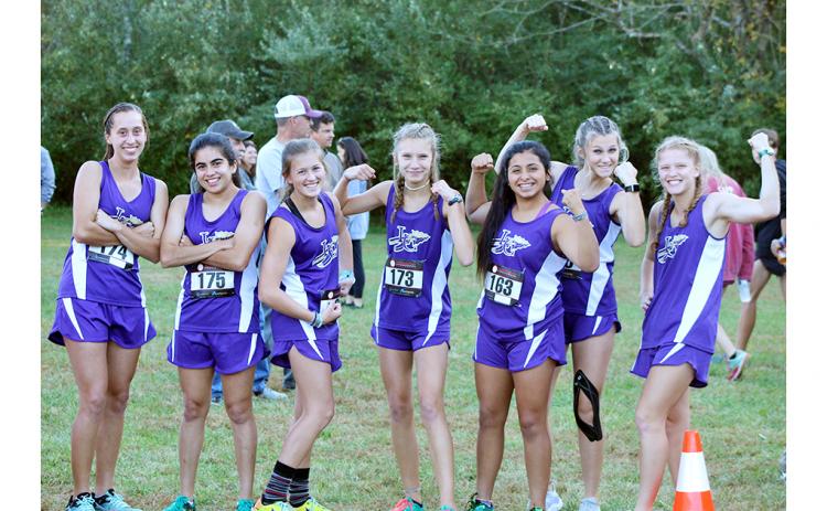The Lady Indians cross country team flexes its muscles before earning a fourth place team finish at the Region 7-AAA championship to advance to the GHSA State Cross Country Championship Meet last week.