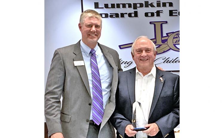 Former Superintendent of Schools David Luke (right) was back at his old stomping ground, the December meeting of the Lumpkin County Board of Education, to accept the Pioneer in Education Award from Justin Old, Director of Pioneer RESA. The award is given to those whose efforts have gone above and beyond to support students and staff.