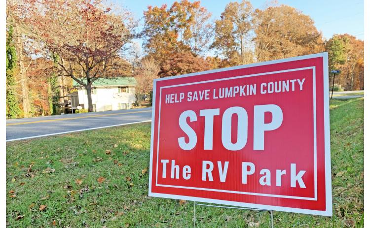 The bright red signs calling for a halt to the proposed RV park have become a familiar sight on the north end of the county.