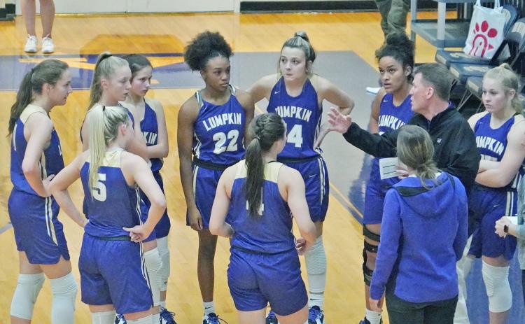 In his first game back since rejoining the team, head coach David Dowse instructs his team with adjustments during a timeout early in Lumpkin’s game against Union County.