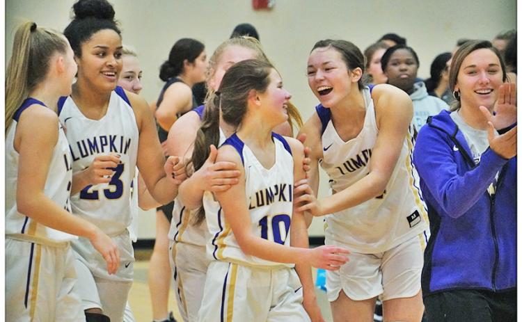 The LCHS Girls Basketball squad celebrates with Breigh Rice (center) following their 72-10 trouncing of West Hall where Rice scored the final points of the game to mark her first career varsity basket.