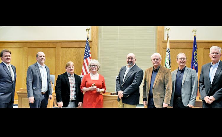 Former and new city council members gathered together at the January 4 meeting, where three new members: Ryan Reagin, far left, Ross Shirley, far right, and Mayor JoAnne Taylor, center, were sworn in.  Also pictured are, from left, council members Roman Gaddis, Johnny Ariemma, former mayor Sam Norton, council members Ron Larson and Joel Cordle.