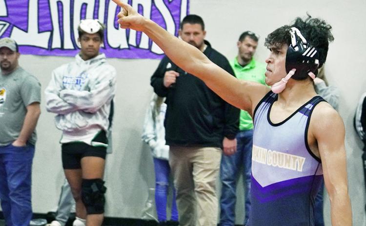After a last-second pin saved his match and put him through to the finals at Sectionals, Lumpkin wrestler Kerwin Martinez points to the crowd in celebration. Martinez often shows emotion after winning important matches, citing that he wrestles to honor those close to him.