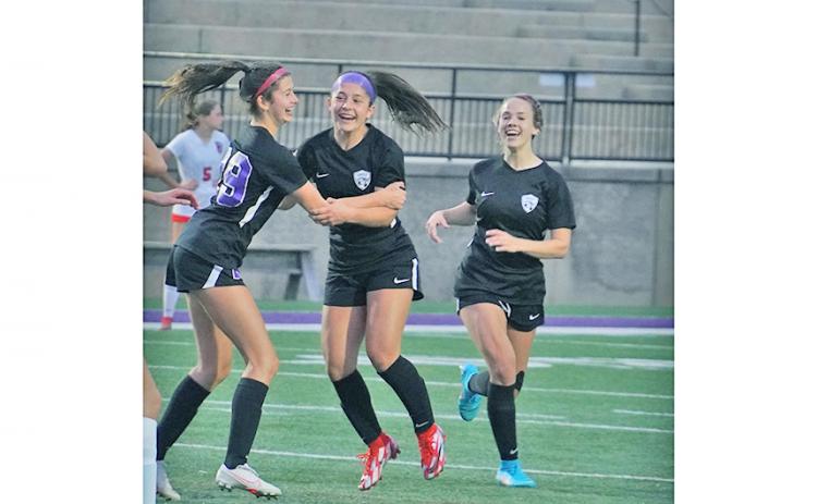 After scoring what turned out to be the game-winning goal in overtime, Andrea Limehouse (left) celebrates with her teammates (from left) Nicole Limehouse and Bri James.