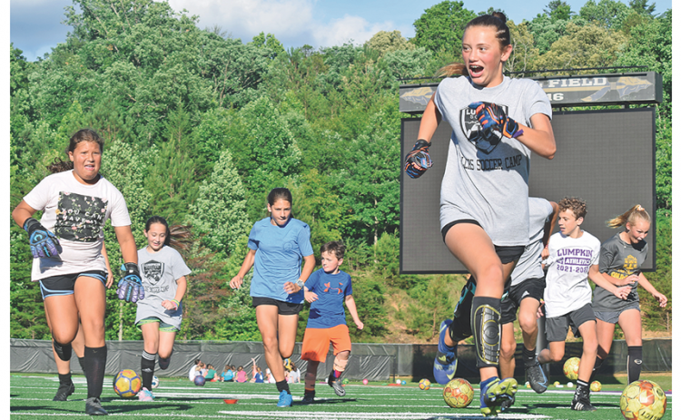 Campers scramble through the gauntlet as a high-intensity version of soccer-dodge-ball tests their agility at the community soccer camp at Lumpkin County High School last week.