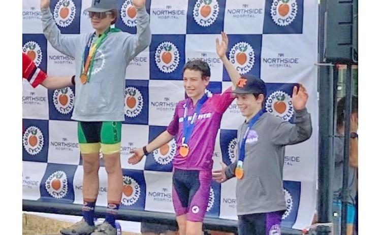 Lumpkin County eighth grader Mathieu Weber (center) finished third at the team’s recent race.