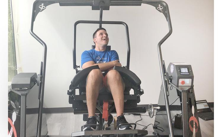 Jon Crais works his core muscles with an AllCore 360 machine. Crais has battled his way back after a traumatic car crash nearly a decade ago.