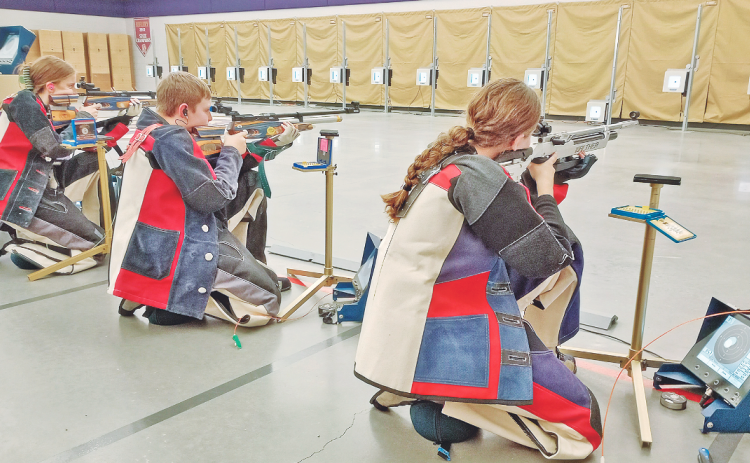 LCHS Rifle team sharpshooters, from left, Laura Hoch, Freshman JT Wright and Brynn Foster take aim while facing off against Riverside on November 15.