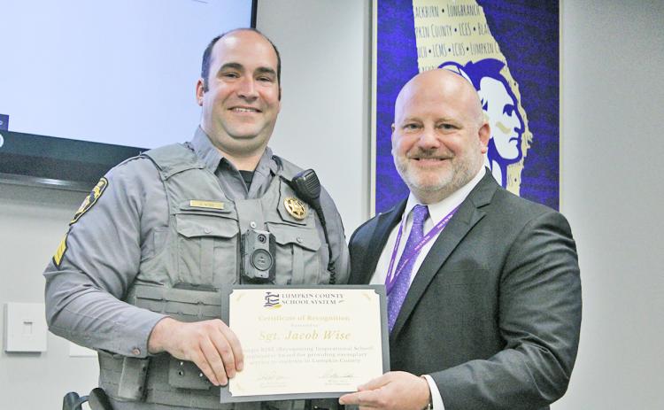 Sergeant Jacob Wise is presented with the 2022 Georgia RISE Award by Lumpkin County Schools Superintendent Dr. Rob Brown.