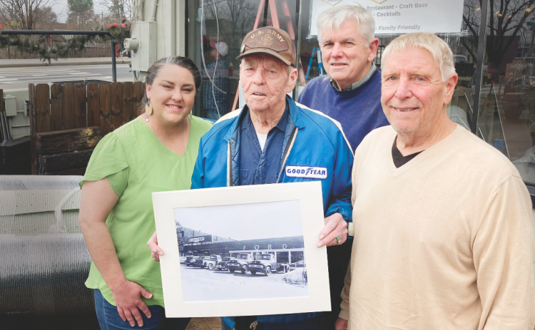 Pictured (from left) operations manager Mea Inglehart, Henry Moore, Jr. (holding a photo of the property from the 1950s), Rick Harris, and owner Art Attaway, took a break during final preparations for the new restaurant last month.