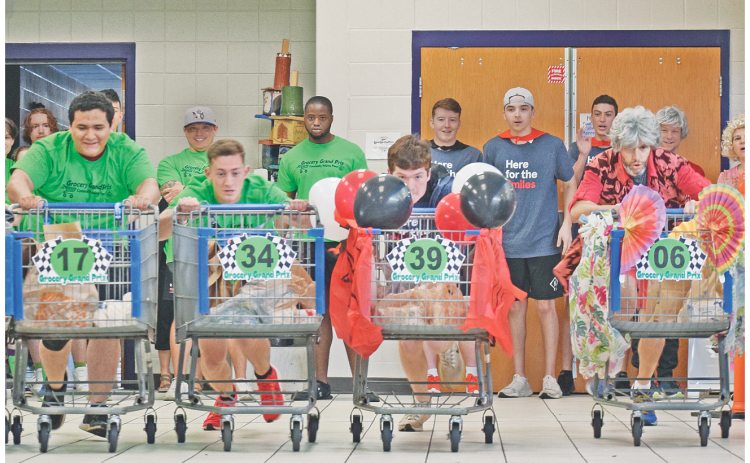 The inaugural Grocery Grand Prix was not only an action-packed event but a profitable fundraiser for the Community Helping Place Food Bank on Saturday. The competition was originally scheduled to take place on the Lumpkin County High School track but moved indoors to the cafeteria due to weather, which made for some tight turns and raucous racing. (photo by Matt Aiken/The Nugget)