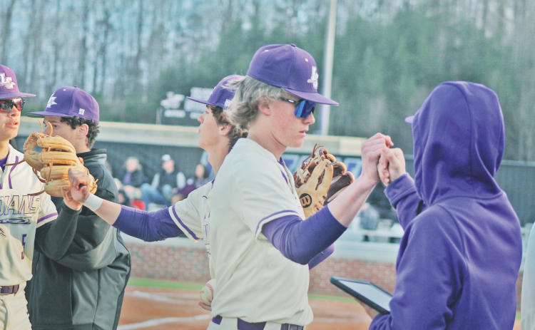 Lumpkin’s Peyton Wood and the Indians team celebrate after retiring the side against Gilmer last week.