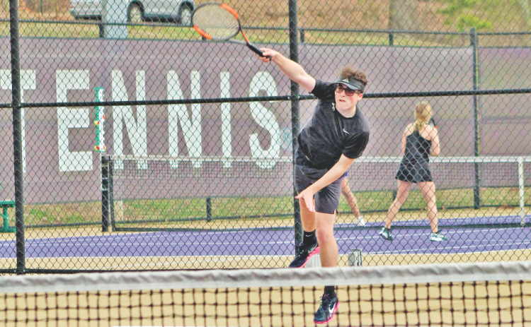 Senior Jack Lowry returns a volley during Lumpkin’s home match last week.