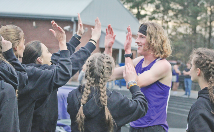 Lumpkin County runner Ben Sherrill celebrates his first pace finish in the 3200-meter event at the Gilmer County meet.