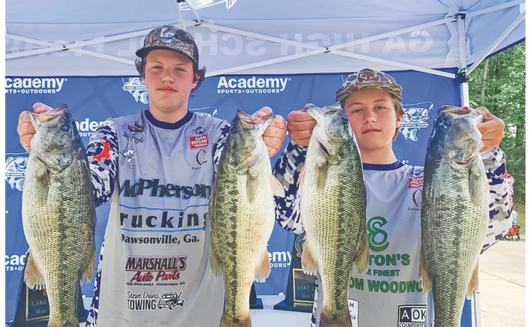 Walker Grizzle and Cooper McDonald show off their catches following a successful tournament on the water.