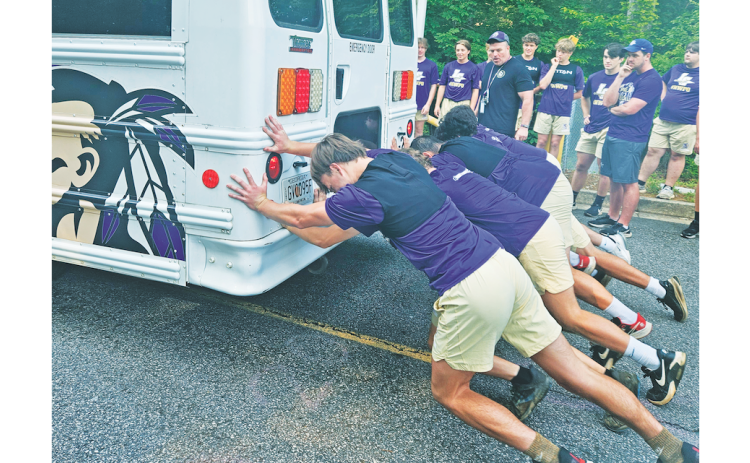 The LCHS football team competes in their first summer burn competition where they raced to push a bus over a long distance.