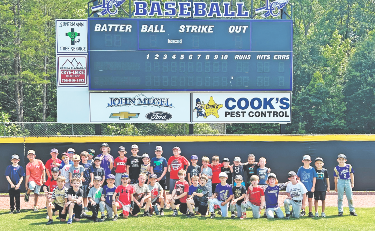 Lumpkin’s young baseball athletes soak up the sun during a group photo following a very successful summer camp.
