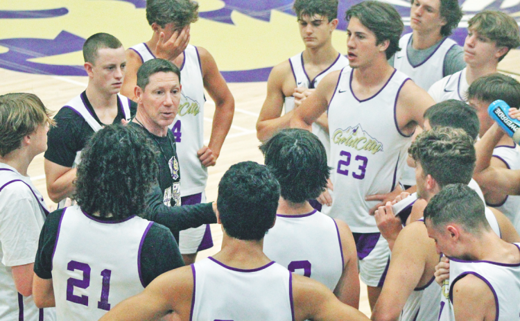 Head Coach Chris Faulkner breaks down strategy during a summer game against East Forsyth.
