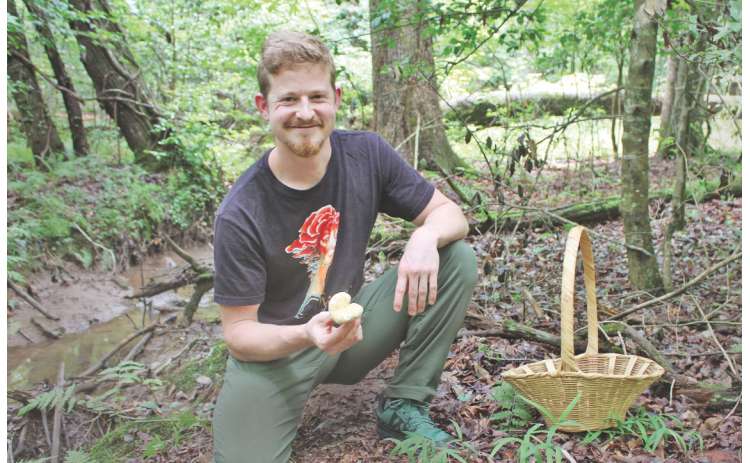 Certified mushroom identification expert and Mindfull Mycology owner Sam Blackstone shows off a wild mushroom he spotted while foraging on his 40-acre property just outside of Dahlonega.
