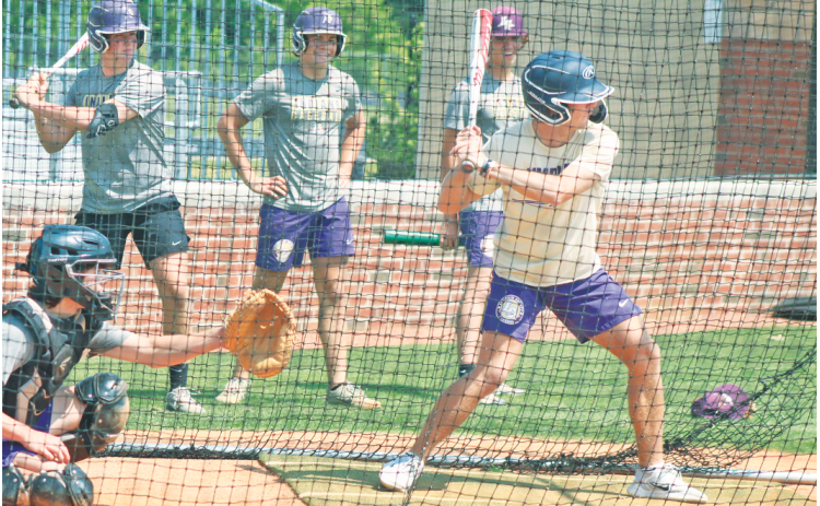 Lumpkin’s Colton Lee steps up to bat, while Kendal Lee sits steadily as the catcher, and Matthew Mitchell, Adian Rogers and Chase Smith look on.