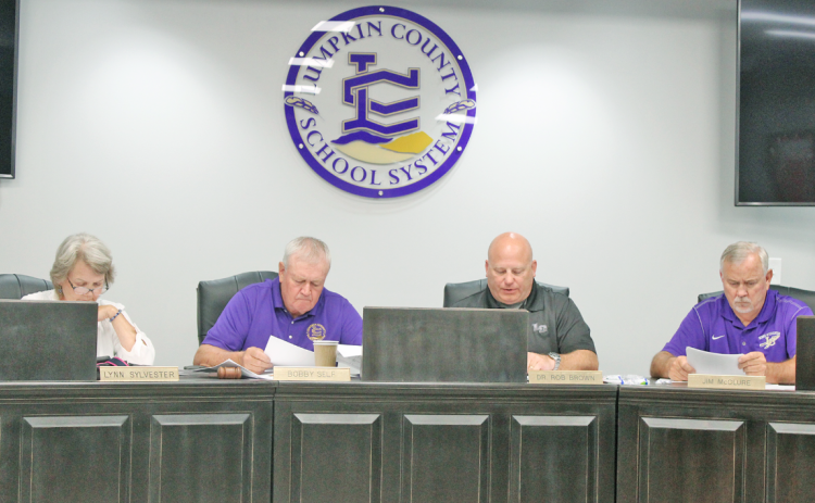 Lumpkin County School Board members compare notes as they deliberate the tentative millage rate for Fiscal Year 2024. Pictured (from left) are Lynn Sylvester, Chairman Bobby Self, Superintendent Rob Brown and Jim McClure.