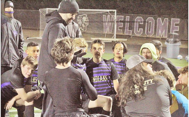 Head Coach Brent Howell talks to his Lumpkin soccer team following a game last season.