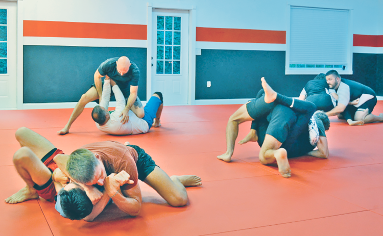 Students grapple with their rolling partners during a lively session at Dahlonega Brazilian Jiu Jitsu.