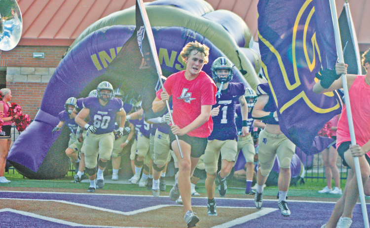 The Lumpkin Crunk Crew and Indians football team storm the field ahead of their game against Banks County.
