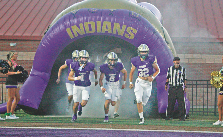 The Indians storm the field ahead of their season opener against Union County on Friday night.