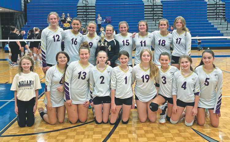 The Lumpkin County Middle School volleyball team celebrates with their new Mountain League Championship trophy.