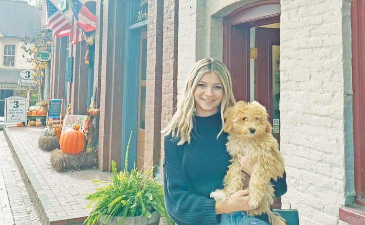 Business owner Abigail Camilleri and her local pup Dilly, celebrate their one year anniversary of opening up their shop on the Public Square.