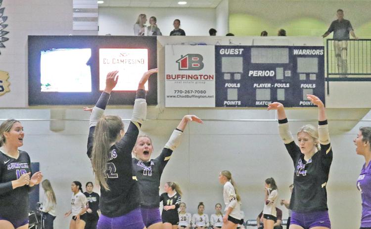 The Lumpkin Lady Indians celebrate scoring a point against Wesleyan.