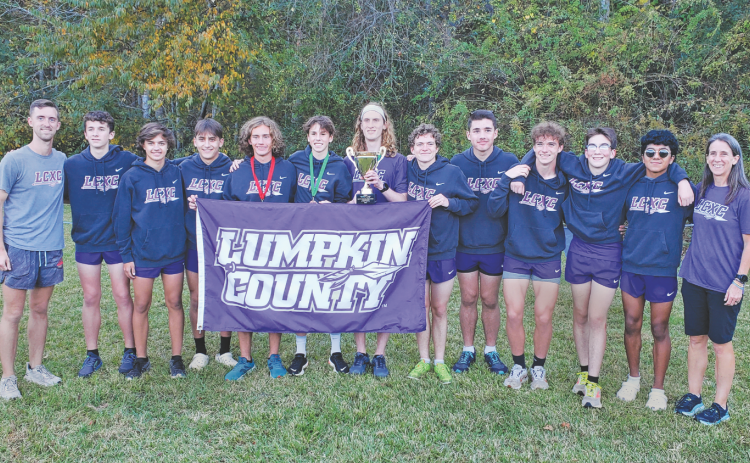 The Lumpkin County boys cross country team won the school’s first cross country region championship last week at the 7-AAA meet at Unicoi State Park near Helen. Members of the team are, from left, head coach Logan Turner, Peter Bowden, Evan Good, Hagen Glenn, Wyatt Windham, Sam Edwards, Ben Sherrill, Jackson Marling, James Bowden, Cooper Marling, Jacob Matthews, Paulo Ramirez and assistant coach Teri Hilchie. (photo by Mark Turner)