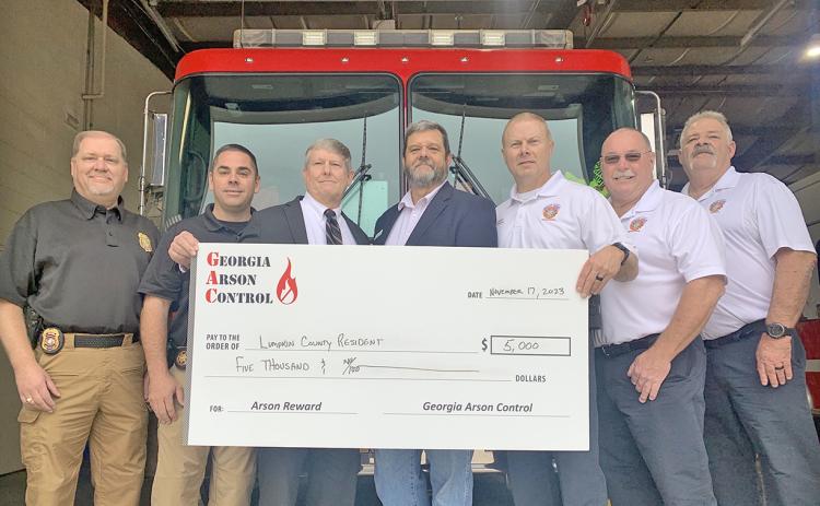 Officials gathered at the downtown fire station recently to hand out a $5,000 reward to a local citizen who provided crucial information in the investigation of a 2021 arson case. On hand were, from left, State Fire Investigator Brian Smith, LCSO Investigator Heath Higman, District Attorney Jeff Langley, Georgia Arson Control consultant Ken LeCroy, Fire Marshal Chris Maloney, Fire Chief David Wimpy and Deputy Fire Chief Tony Kent.