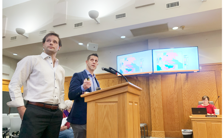 During the recent City Council public hearing, consultant Logan Moye, left, and zoning attorney Ethan Underwood discuss the proposal that could bring a 228-unit townhome development to a 62.77 acre plot just off of Pinetree Way in downtown Dahlonega.