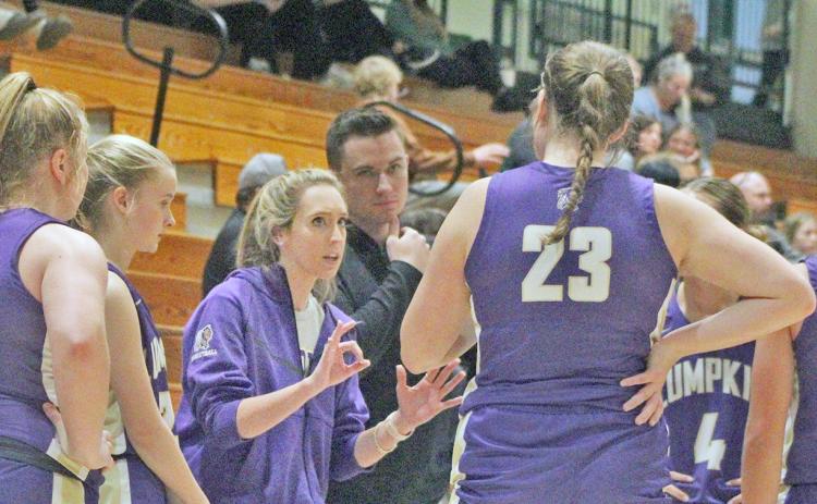 Lumpkin County girls Head Coach Tess Wright takes a moment with her team during a recent game.