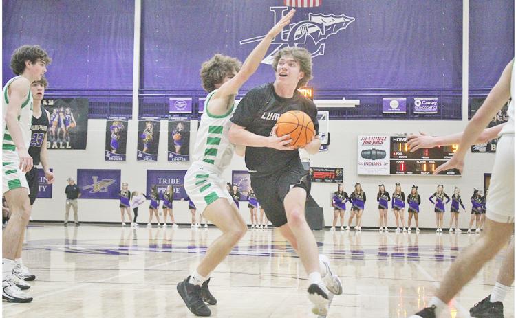 Lumpkin County’s TJ Gaddis powers his way in for a layup.