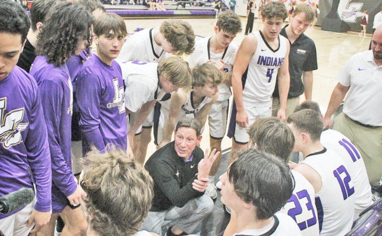 Lumpkin boys basketball Head Coach Chris Faulkner talks with his team during a timeout in the Indians’ game versus Dawson County last week.