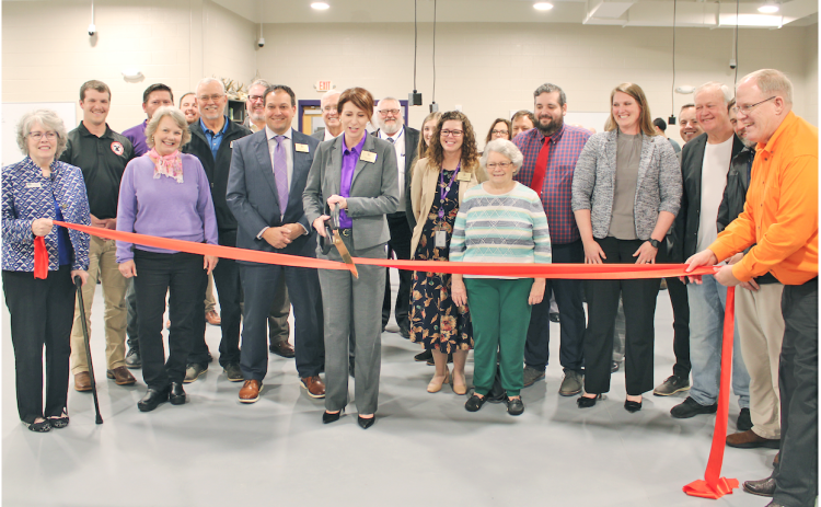 Lumpkin County Superintendent Sharon Head cuts a ceremonial ribbon in the College & Career Academy’s agricultural lab as local school board members, elected officials and project managers look on.
