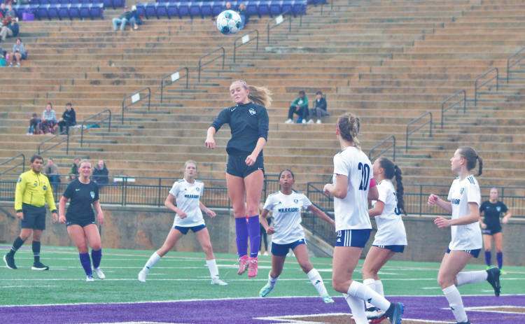 Kaitlyn Johnson lands a header during the team’s game against White County.
